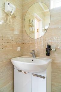 a bathroom with a sink and a mirror at Ordo Hotel in Karakol +87 photos