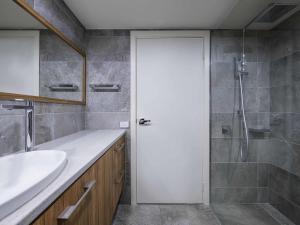 a bathroom with a shower and a white door at The Sebel Pinnacle Valley in Merrijig +66 photos
