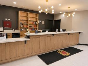a restaurant with a counter and a counter at Super 8 by Wyndham Brenham TX in Brenham