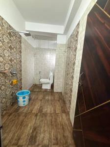 a bathroom with a toilet and a bucket at Haven Stay in Panchanai +4 photos