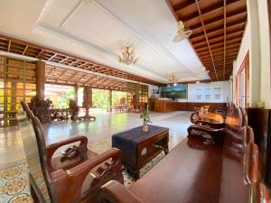 a large living room with a table and chairs at ASANA Villas in Siem Reap