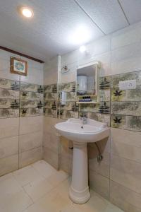a bathroom with a sink and a mirror at Prideinn Luxury Resort in Rishīkesh