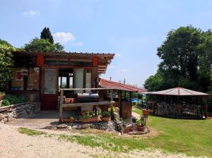 a small shed with a table and umbrella at Brojo Hill in Longare