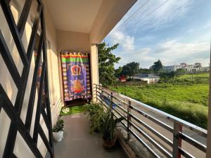 a balcony with a colorful tapestry on the wall at Haven Stay in Panchanai
