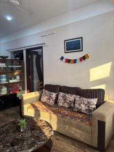 a living room with a couch and a table at Haven Stay in Panchanai