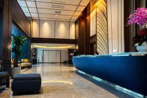 a lobby with a large blue counter in a building at Mandala Pearl Resort in Phan Thiet +53 photos