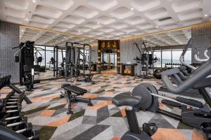 a gym with several treadmills and cardio machines at Mandala Pearl Resort in Phan Thiet