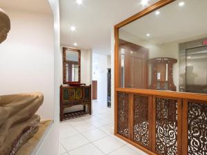 a living room with a mirror and a room with a couch at Noosa Dua 2 Balinese Retreat in Noosa Heads