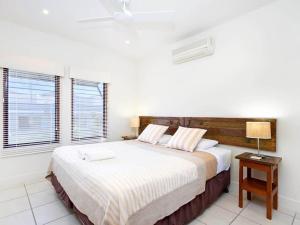 a bedroom with a large bed and a night stand at Noosa Dua 2 Balinese Retreat in Noosa Heads +11 photos
