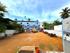 a building with motorcycles parked in front of it at DPD Beach Hotel in Pondicherry