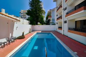 a swimming pool in the backyard of a house at Roy Arias Suites & Residences in Santo Domingo