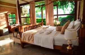 a bedroom with a bed with a large window at Ella Dream Mount in Ella