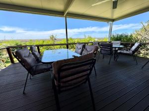 a table and chairs on a deck with a view at Backyard Bliss in Waikerie