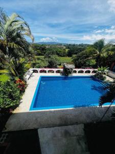 a swimming pool in front of a house at Casa Eliza in Alajuela