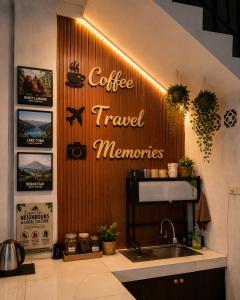 a sign on the wall of a coffee travel memories at Medan Dazhong Backpacker's Hostel in Medan