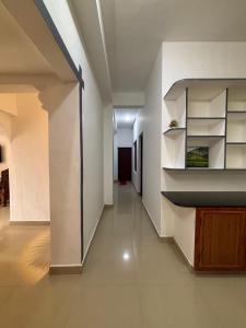 a hallway of a house with white walls and shelves at Homestay INN in Anachal