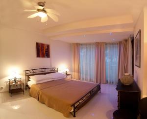 a bedroom with a bed and a ceiling fan at Residence Apartments Anamaria in Podstrana
