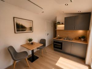 a kitchen with a table and chairs in a room at Hassberge Chalets in Kirchlauter
