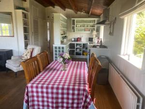 a kitchen with a table with a checkered table cloth at Roberts’ Cottage in Westport +31 photos