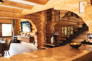 a kitchen and dining room with a wooden wall at Casa Di Giorgio in Borsa