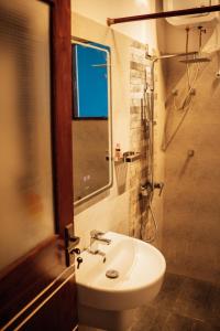 a bathroom with a sink and a shower at US Apartment in Nochchiyagama