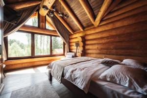 a bedroom with a bed in a log cabin at Casa Di Giorgio in Borsa