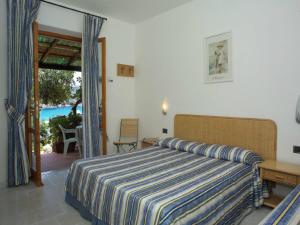 a bedroom with a bed and a view of the ocean at Hotel Danila in Portoferraio