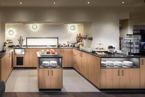 a large kitchen with wooden cabinets and counters at Edelweiss echt-charmant in Sölden