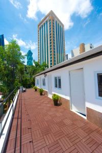 a balcony with a brick floor and a building at Hostal Loco Coco Loco in Panama City