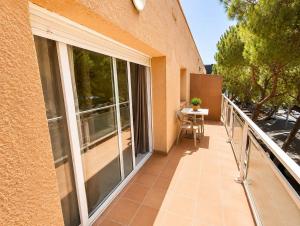 a balcony of a building with sliding glass doors at Apartamentos Baymar Playa de Aro in Platja d'Aro