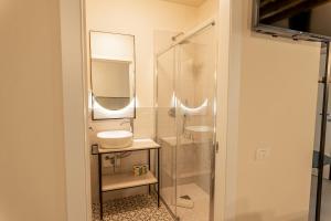 a bathroom with a sink and a glass shower at Montenero City Rooms in Verona