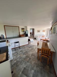 a kitchen and living room with a table and chairs at Palm Heights in Palm Beach +8 photos