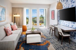 a living room with a couch and a desk at Wild Dunes Resort - Sweetgrass Inn and Boardwalk Inn in Isle of Palms