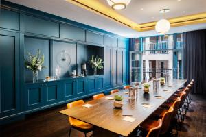 a conference room with a long table and chairs at Dream Nashville, by Hyatt in Nashville