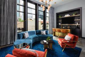 a living room with a blue couch and chairs at Dream Nashville, by Hyatt in Nashville