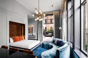 a living room with a bed and a couch and a window at Dream Nashville, by Hyatt in Nashville +90 photos