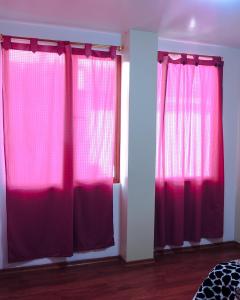 a room with two red curtains in a bedroom at Alojamiento Primer Piso Confort Riobamba in Riobamba +11 photos