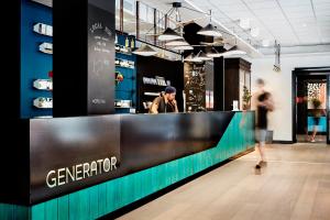 a man standing at a counter in a store at Generator Stockholm in Stockholm