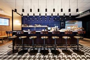 a restaurant with a bar with stools at Generator Stockholm in Stockholm