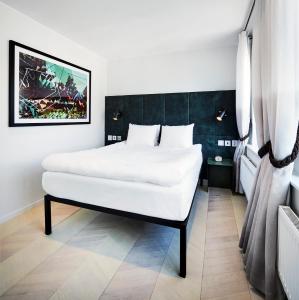 a bedroom with a large white bed in a room at Generator Stockholm in Stockholm