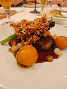 a white plate of food on a table at Hotel Gasthaus Hecht in Wolfach +6 photos