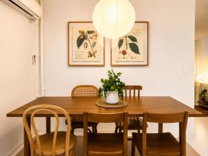 a dining room with a wooden table and chairs at TOV stay in Seoul