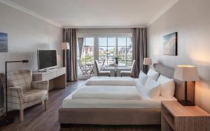 a hotel room with two beds and a television at Dorint Strandresort & Spa Westerland/Sylt in Westerland +34 photos
