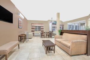 a living room with a couch and a table at Microtel Inn & Suites Mansfield PA in Mansfield