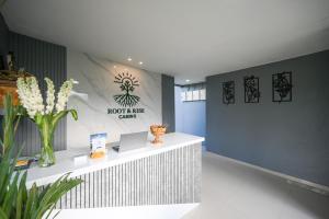 a lobby with a counter with flowers on it at Root and Rise Cabins in Tabanan