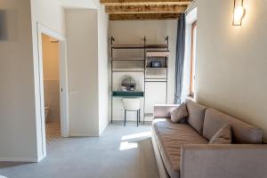 a living room with a couch and a table at Montenero City Rooms in Verona