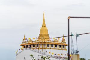 a building with a golden steeple on top of it at Siam Place - Spacious Family House in Bangkok in Bangkok