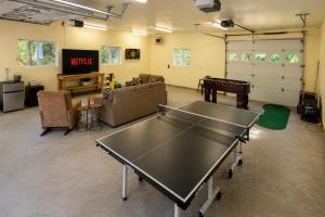 a living room with a ping pong table in it at Pine River Retreat in Leavenworth
