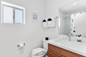 a bathroom with a sink and a toilet and a mirror at Contemporary Studio Hub in DTPH - Pool & Parking in Phoenix +26 photos