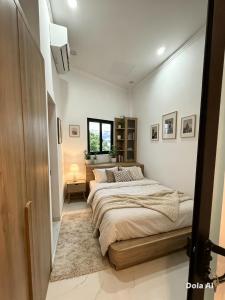 a bedroom with a large bed and a window at Sunrak House in Ðạo Thành